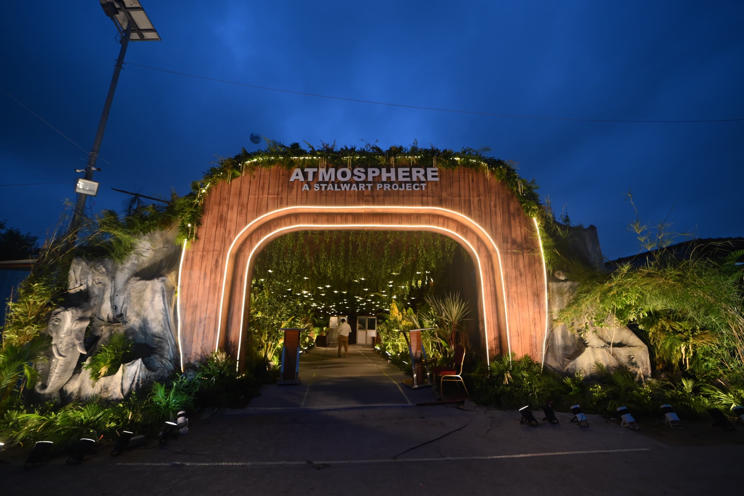 Illuminated entrance arch flanked by carved elephant sculptures